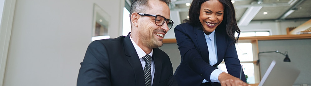 Two colleagues laughing together