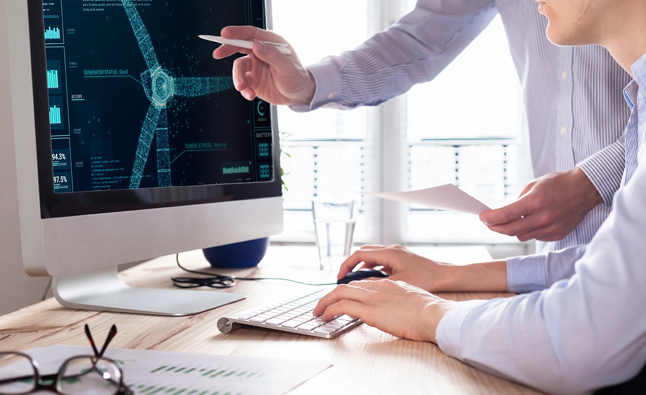 Two professionals in front of computer screen
