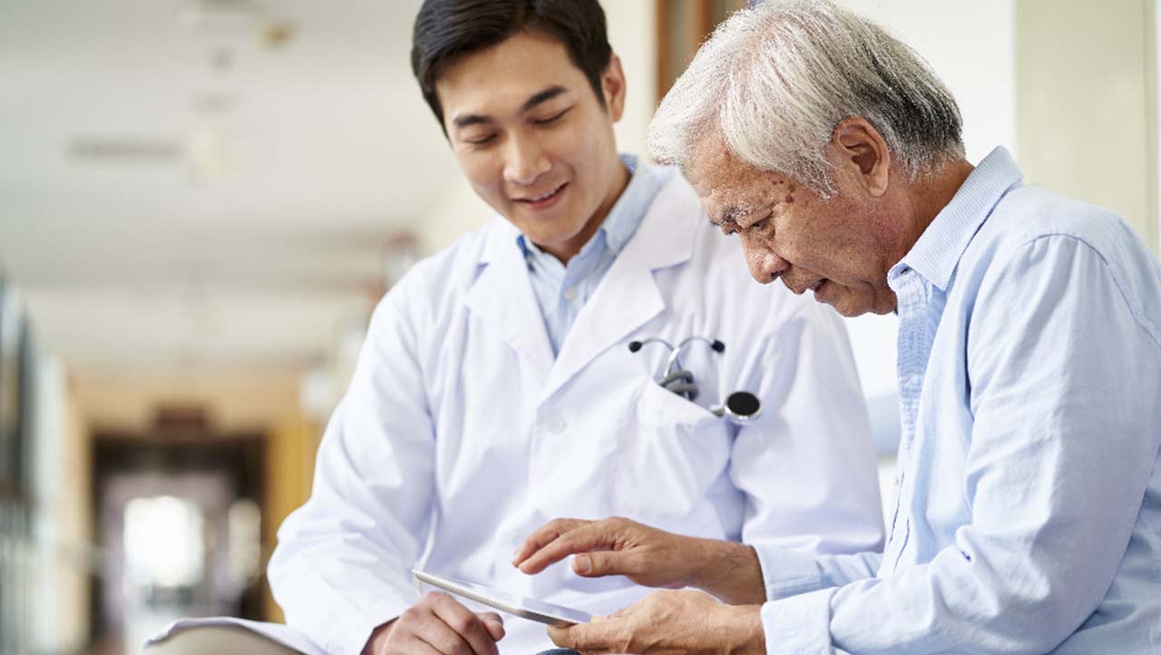 healthcare professional helping patient use a tablet healthcare professional helping patient use a tablet
