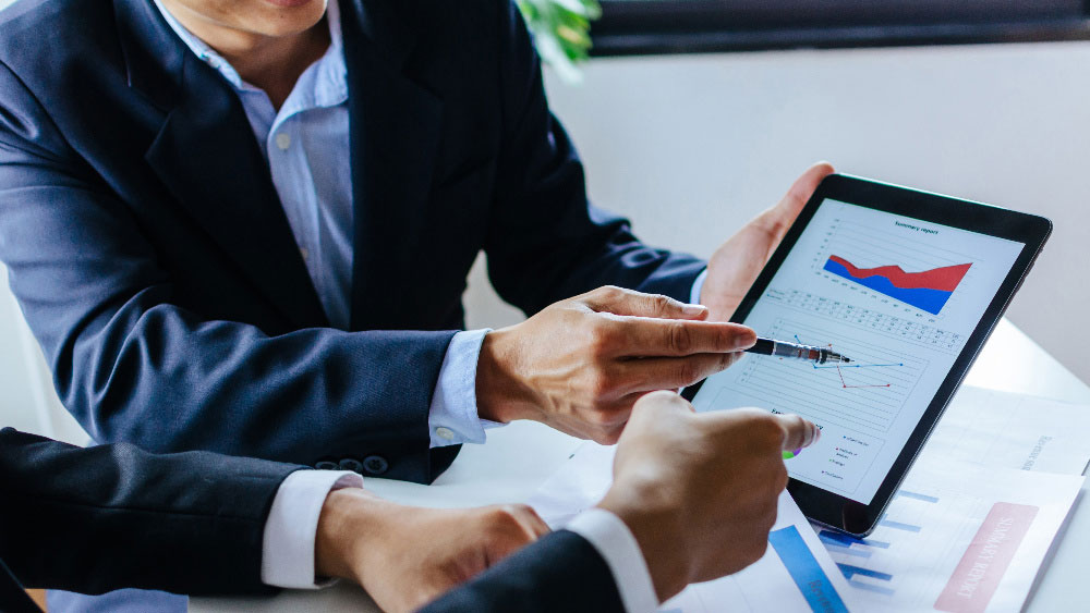 Consultants discussing business on a tablet