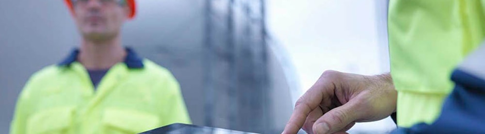 Workers looking at stats and diagrams on clipboard