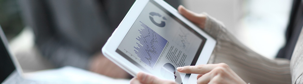 Person holding tab looking at analytics