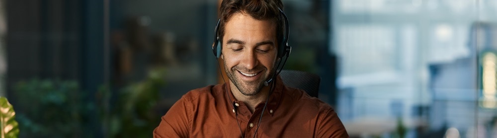 Person on laptop with headphones Person on laptop with headphones