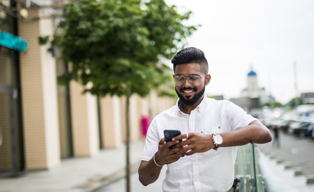 Person using mobile phone in streets