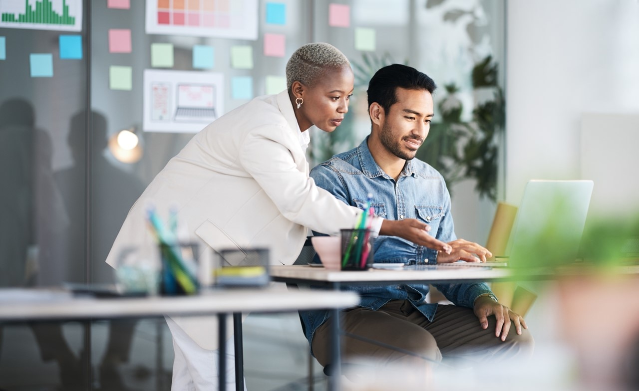 Woman and man looking at laptop