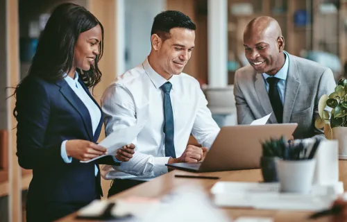 professionals collaborating at a laptop