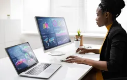 person analyzing data on two monitors