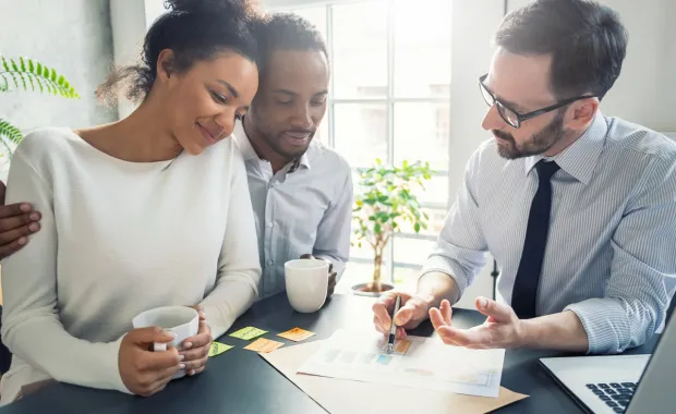couple reviewing documents with insurance expert