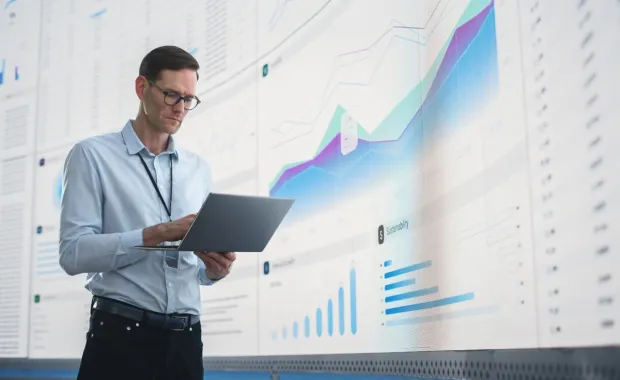 IT programmer working on computer in data center system control room