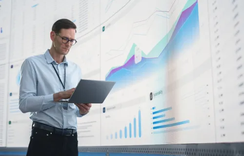 IT programmer working on computer in data center system control room