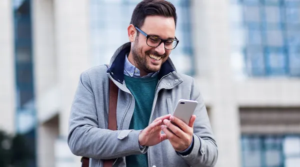 man smiling looking at the phone