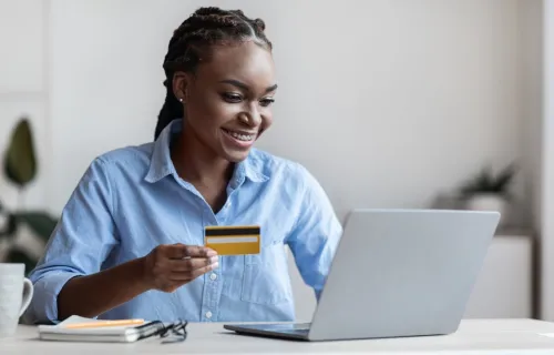 Person holding credit card and making online payment