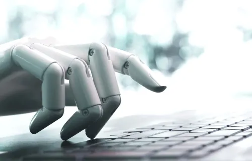 Robot hand typing on keyboard